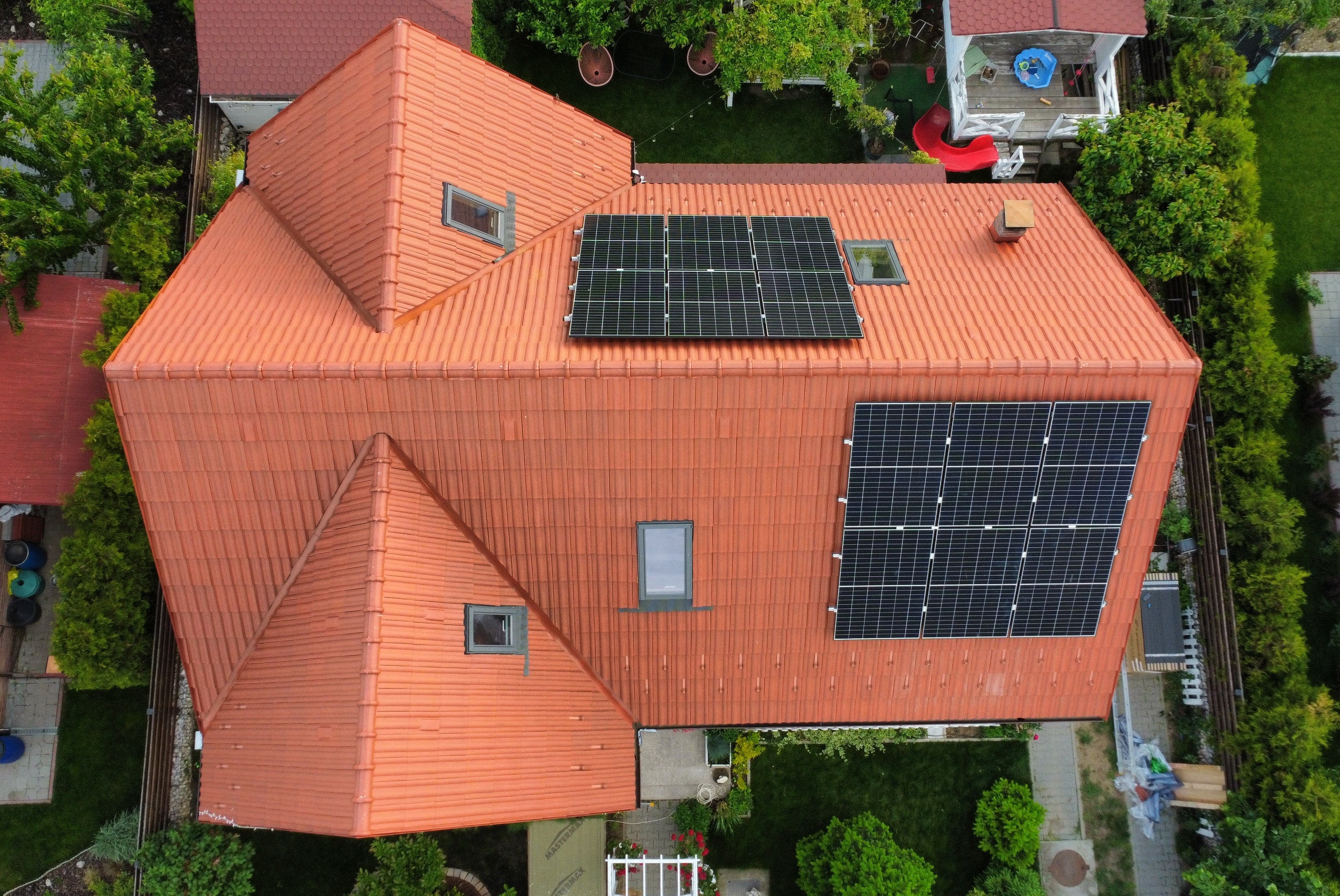 Aerial view of a house with solar panels on the roof